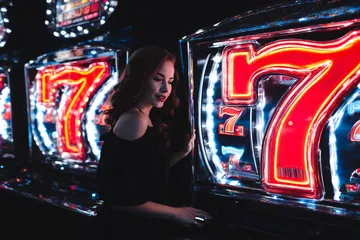 A stylish woman beside vibrant slot machines displaying glowing sevens, showcasing the variety of top slots at 4777GEM.